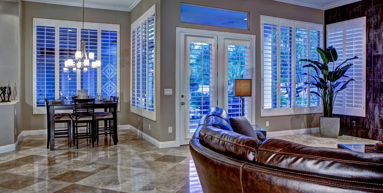 Boston great room with classic shutters and leather furniture.